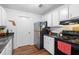 Well-lit kitchen with stainless steel appliances, white cabinets and modern countertops at 2819 47Th S Ave, St Petersburg, FL 33712