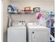 Bright laundry room with washer, dryer, and shelving for storage at 2819 47Th S Ave, St Petersburg, FL 33712