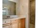 Updated bathroom with wood vanity, tiled shower, and large mirror at 3241 Rogue St, North Port, FL 34291