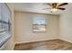 Bedroom with wood-look floors, window with blinds, and ceiling fan at 3241 Rogue St, North Port, FL 34291