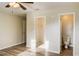 Bright bedroom with wood-look floors, ceiling fan, and private access to bathroom at 3241 Rogue St, North Port, FL 34291