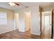 Bedroom with wood-look floors, multiple entrances, and access to hallway at 3241 Rogue St, North Port, FL 34291