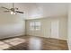 Spacious living room featuring wood-look vinyl flooring and a ceiling fan at 3241 Rogue St, North Port, FL 34291