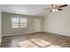 Bright living room with vinyl flooring and ceiling fan at 3241 Rogue St, North Port, FL 34291