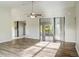 Living room with vinyl plank flooring and sliding doors to a patio at 3241 Rogue St, North Port, FL 34291