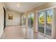 Bright sunroom with tile floors and sliding glass doors leading to backyard at 3241 Rogue St, North Port, FL 34291