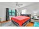 Bright bedroom featuring hardwood floors, a plush bed, and patterned curtains at 3512 Haines N Rd, St Petersburg, FL 33704