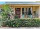 Inviting front porch with seating, plants, and a decorative storm door at 3512 Haines N Rd, St Petersburg, FL 33704