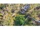 Aerial view of a serene backyard, enclosed by a white fence, shaded by mature trees at 415 5Th N St, Safety Harbor, FL 34695