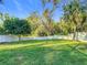 Spacious backyard with lush grass and a white picket fence at 415 5Th N St, Safety Harbor, FL 34695