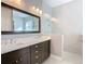 Bright bathroom with a double vanity with dark wood cabinets and a sleek glass-enclosed shower at 415 5Th N St, Safety Harbor, FL 34695