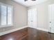 This bedroom features hardwood floors, a bright window with shutters, and a neutral color palette at 415 5Th N St, Safety Harbor, FL 34695