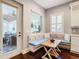 Cozy breakfast nook with custom bench seating and natural light flowing from a nearby door and windows at 415 5Th N St, Safety Harbor, FL 34695