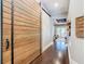 Stylish hallway featuring hardwood floors and a decorative sliding barn door at 415 5Th N St, Safety Harbor, FL 34695