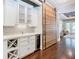 Hallway featuring a sliding barn door, wine rack, and elegant decor at 415 5Th N St, Safety Harbor, FL 34695