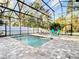 Screened-in pool with a sun deck and seating area at 415 5Th N St, Safety Harbor, FL 34695