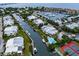 Beautiful aerial view of waterfront homes, boat docks, pool, and tennis courts at 4212 126Th W St # 401, Cortez, FL 34215