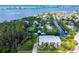 Beautiful waterfront property featuring a three-story building with lush landscaping and boating access to the open bay at 4212 126Th W St # 401, Cortez, FL 34215