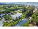 Beautiful waterfront property featuring a three-story building with lush landscaping, canal, and boat docks at 4212 126Th W St # 401, Cortez, FL 34215