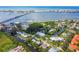 Stunning aerial view of waterfront homes with boat docks, canal access, and a bridge to the pristine beach at 4212 126Th W St # 401, Cortez, FL 34215