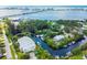Picturesque aerial shot of waterfront condo with a serene canal, boat docks, and lush vegetation at 4212 126Th W St # 401, Cortez, FL 34215