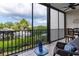 Cozy screened balcony boasts water views, seating and tiled floor at 4212 126Th W St # 401, Cortez, FL 34215