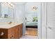 Bright bathroom with a wooden vanity, white sink, and views to the main bedroom at 4212 126Th W St # 401, Cortez, FL 34215