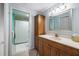 Bright bathroom features a wooden vanity with sink and mirror and a shower with white curtain at 4212 126Th W St # 401, Cortez, FL 34215