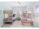 Bright bedroom with light blue walls and two sets of wooden bunk beds at 4212 126Th W St # 401, Cortez, FL 34215