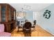 Cozy dining room features a glass table, wooden chairs, and built-in hutch at 4212 126Th W St # 401, Cortez, FL 34215