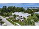 Modern multi-story condo with white facade, flat roof, lush landscaping and view of bay at 4212 126Th W St # 401, Cortez, FL 34215