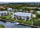 Waterfront condo showcasing multiple levels, boat dock, and manicured landscaping at 4212 126Th W St # 401, Cortez, FL 34215