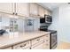 Updated kitchen boasts granite counters and stainless steel appliances at 4212 126Th W St # 401, Cortez, FL 34215