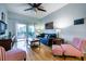 Bright living room with ceiling fan, hardwood floors, and a comfortable blue couch at 4212 126Th W St # 401, Cortez, FL 34215