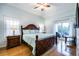 Light-filled main bedroom with hardwood floors, ceiling fan, and balcony access at 4212 126Th W St # 401, Cortez, FL 34215