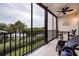 Enclosed waterfront lanai with lovely seating and ceiling fan overlooking a canal at 4212 126Th W St # 401, Cortez, FL 34215