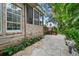 Stone patio, lush landscaping, and screened porch at 4421 W Sevilla St, Tampa, FL 33629