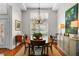 Formal dining room featuring a large table, chandelier, and hardwood floors at 4421 W Sevilla St, Tampa, FL 33629