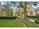 Two-story brick home with large tree and manicured lawn at 4421 W Sevilla St, Tampa, FL 33629