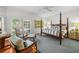 Main bedroom with a four-poster bed, hardwood floors, and large windows at 4421 W Sevilla St, Tampa, FL 33629