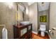 Elegant powder room with vessel sink, dark wood vanity, and textured wallpaper at 4421 W Sevilla St, Tampa, FL 33629