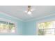 Light blue room with ceiling fan and two windows at 4643 Bay Crest Dr, Tampa, FL 33615