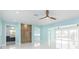 Spacious living area with light blue walls, white floors, and modern wooden accents at 4643 Bay Crest Dr, Tampa, FL 33615