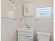 A clean and minimalist bathroom featuring a vanity, toilet, and tiled walls at 4851 W Gandy Blvd # B2L25, Tampa, FL 33611