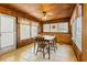 Charming dining area featuring wood paneling, tile floors, and an antique dining table and chairs at 4851 W Gandy Blvd # B2L25, Tampa, FL 33611