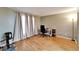 Bright bedroom featuring wood floors, natural light from the window, and a home office setup at 4917 Puritan Cir, Tampa, FL 33617