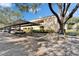 Exterior view of building and carports with mature landscaping at 4917 Puritan Cir, Tampa, FL 33617