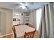 A quaint dining room with light green walls, a ceiling fan, and a view into the kitchen at 4917 Puritan Cir, Tampa, FL 33617