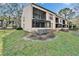 Spacious lawn of the condo exterior featuring mature tree and central A/C at 4917 Puritan Cir, Tampa, FL 33617