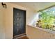 Close up of front door featuring unit number and a small garden at 4917 Puritan Cir, Tampa, FL 33617